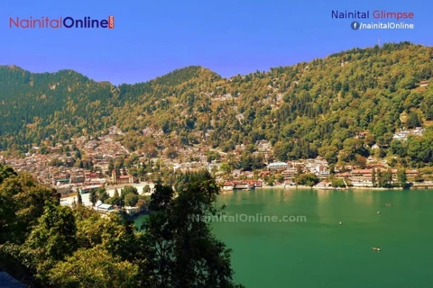 Naini Lake with hillside homes and forest in Nainital